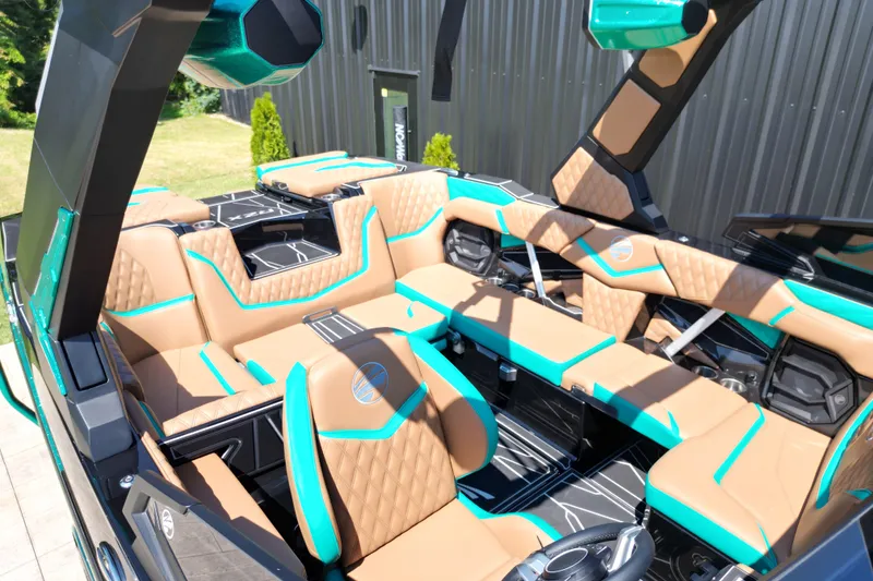 Slide: The Image of Luxurious interior of 2027 Tigé 22RZX boat with tan and teal seating. - 9
