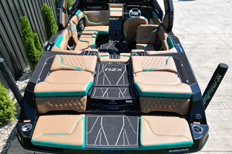 Slide: The Image of 2027 Tigé 22RZX boat interior with tan and teal seating, modern design. - 13