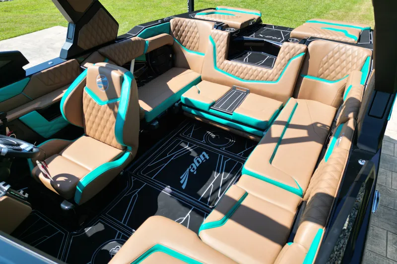 Slide: The Image of Luxurious interior of 2027 Tigé 22RZX boat with tan and teal seating. - 7