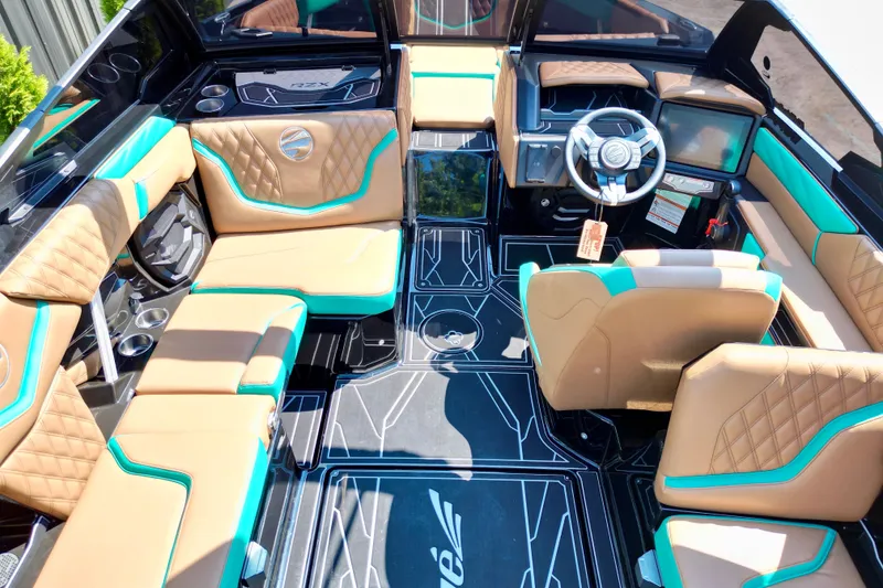 Slide: The Image of Luxurious interior of 2027 Tigé 22RZX boat with tan and teal seating. - 12