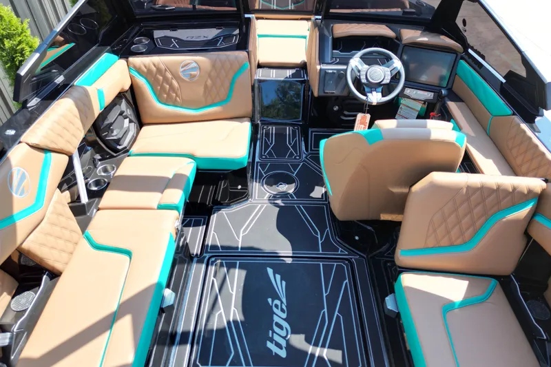 Slide: The Image of Luxurious interior of 2027 Tigé 22RZX boat with tan and teal seating. - 11
