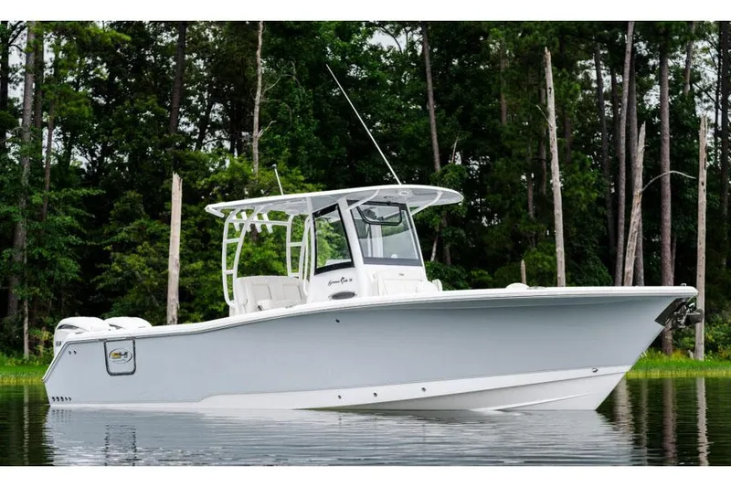 Slide: The Image of Manufacturer Provided Image: 2025 Sea Hunt Gamefish 30 Forward Seating boat on calm water, surrounded by trees. - 4