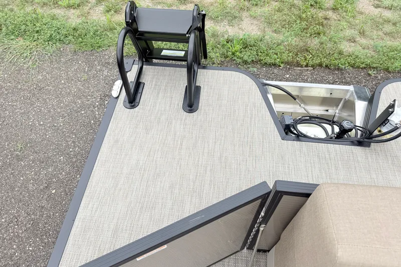 Slide: The Image of Manitou Aurora SE 21 boat deck, 2027 model, featuring a ladder and storage compartment. - 12
