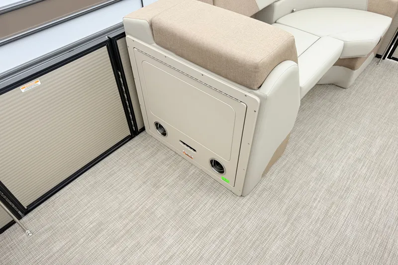 Slide: The Image of Interior of 2027 Manitou Aurora SE 21 pontoon boat with beige seating and storage compartment. - 6