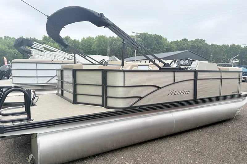 Slide: The Image of 2027 Manitou Aurora SE 21 pontoon boat with sleek design, parked outdoors. - 3