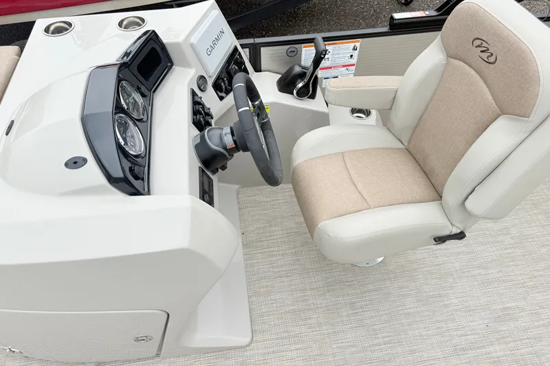 Slide: The Image of Captain's seat and dashboard of 2027 Manitou Aurora SE 21 boat with Garmin system. - 9