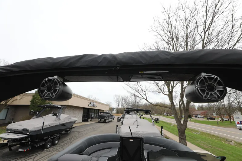 Slide: The Image of 2024 Viaggio D24U boat with speakers, parked near a showroom on a cloudy day. - 9