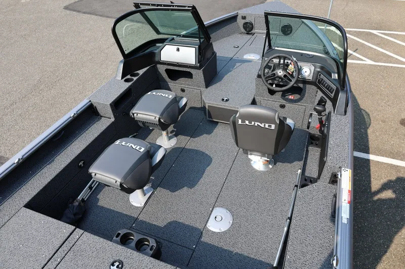 Slide: The Image of 2027 Lund 1875 Impact XS Sport boat interior with seating and steering console. - 45