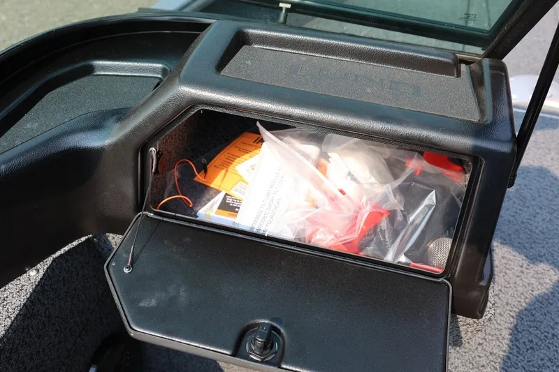 Slide: The Image of Storage compartment of 2027 Lund 1875 Impact XS Sport boat, containing various items. - 33