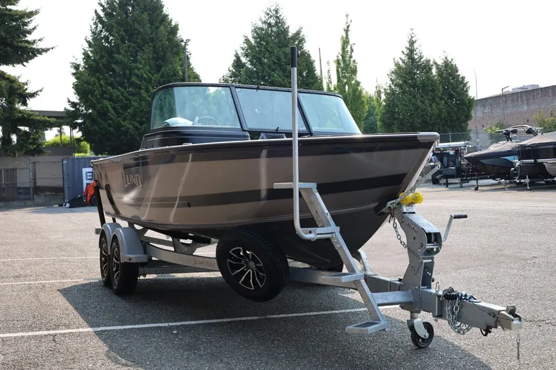 Slide: The Image of 2027 Lund 1875 Impact XS Sport boat on trailer in parking lot. - 10