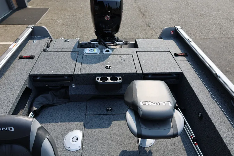 Slide: The Image of 2027 Lund 1875 Impact XS Sport boat interior with seating and storage compartments. - 35