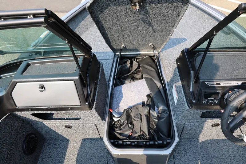 Slide: The Image of 2027 Lund 1875 Impact XS Sport boat interior with open storage compartment. - 23