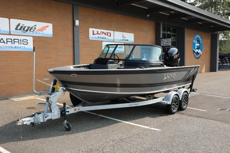 Slide: The Image of 2027 Lund 1875 Impact XS Sport boat on trailer outside dealership. - 13