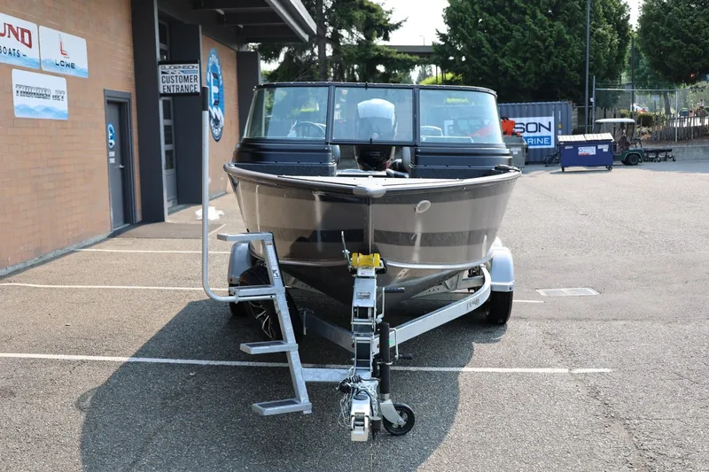 Slide: The Image of 2027 Lund 1875 Impact XS Sport boat on trailer in parking lot. - 11