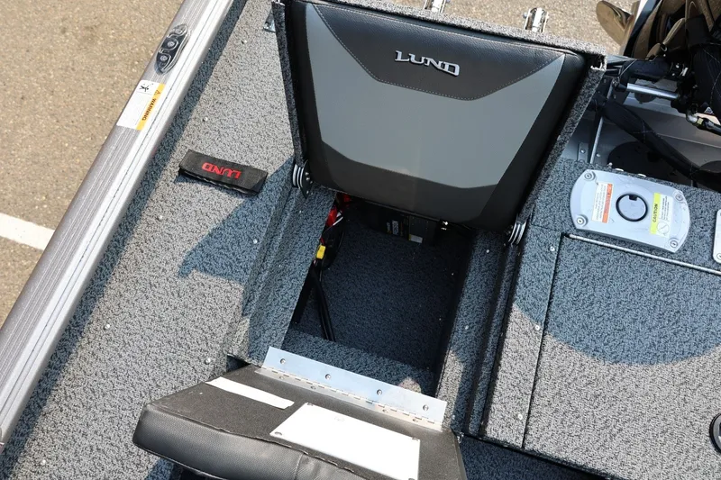 Slide: The Image of 2027 Lund 1875 Impact XS Sport boat interior with seating and storage compartments. - 42