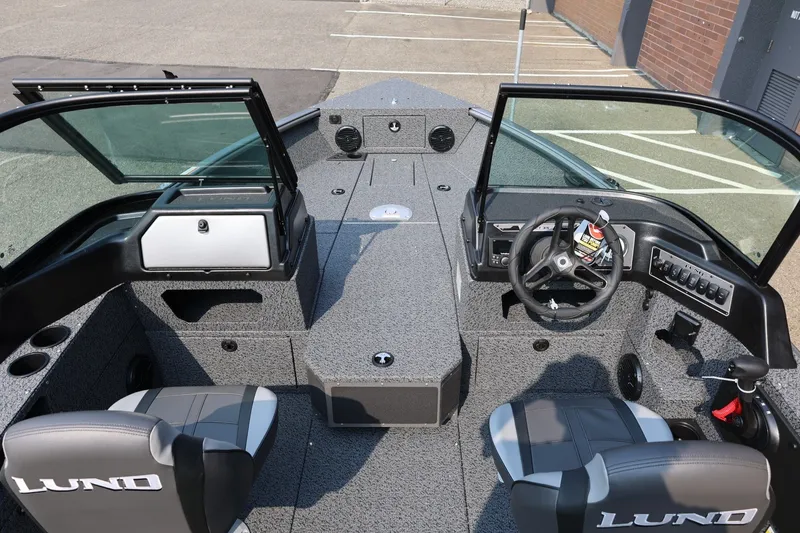 Slide: The Image of 2027 Lund 1875 Impact XS Sport boat interior with dual seats and steering console. - 22