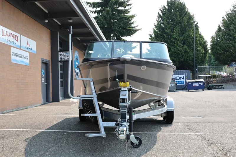 Slide: The Image of 2027 Lund 1875 Impact XS Sport boat on trailer outside dealership. - 12