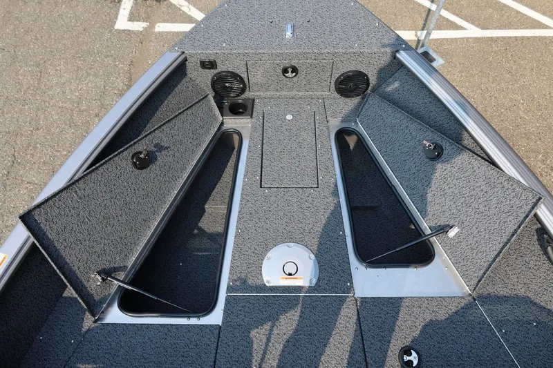 Slide: The Image of 2027 Lund 1875 Impact XS Sport boat interior with open storage compartments. - 18