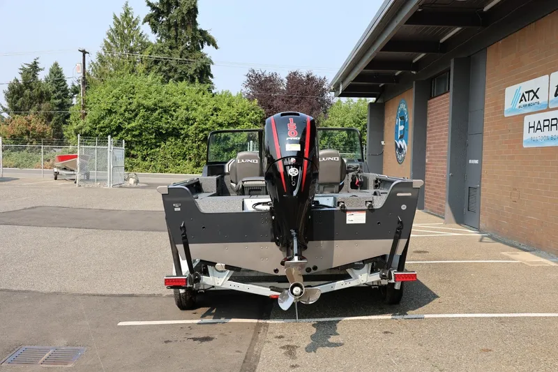 Slide: The Image of 2027 Lund 1875 Impact XS Sport boat parked outside dealership. - 5
