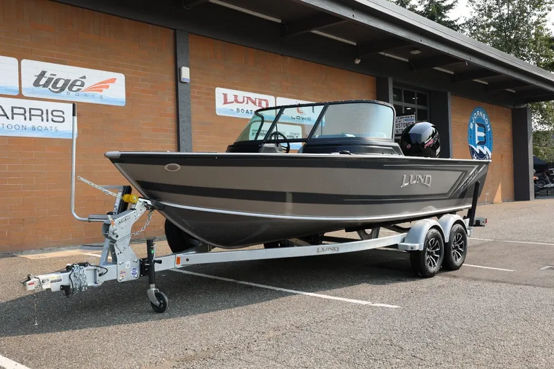 Slide: The Image of 2027 Lund 1875 Impact XS Sport boat on trailer outside dealership. - 14