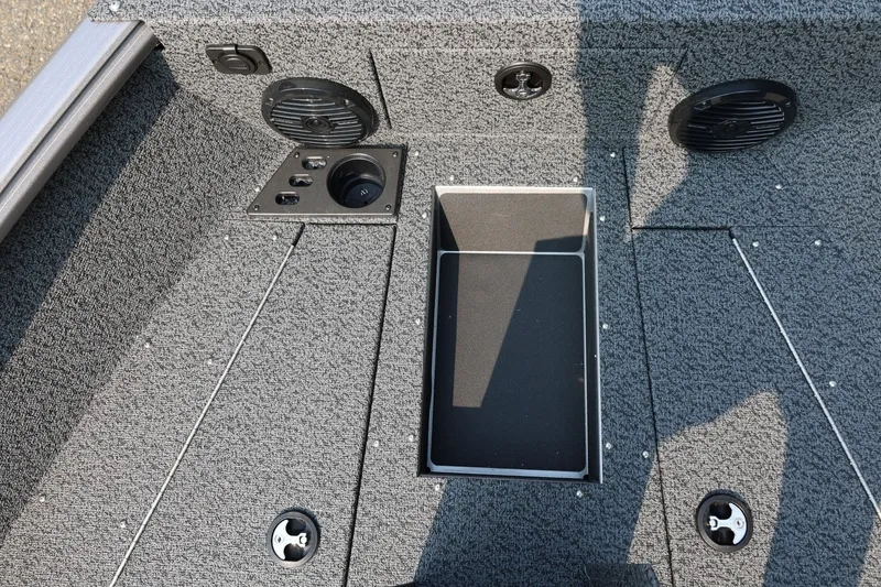 Slide: The Image of 2027 Lund 1875 Impact XS Sport boat interior with storage compartment and speakers. - 20