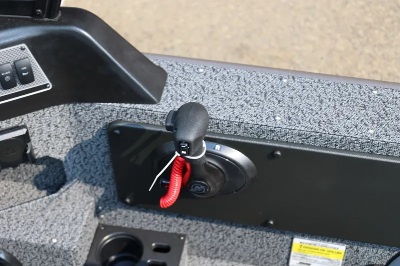 Slide: The Image of Control panel of 2027 Lund 1875 Impact XS Sport boat with throttle lever. - 27