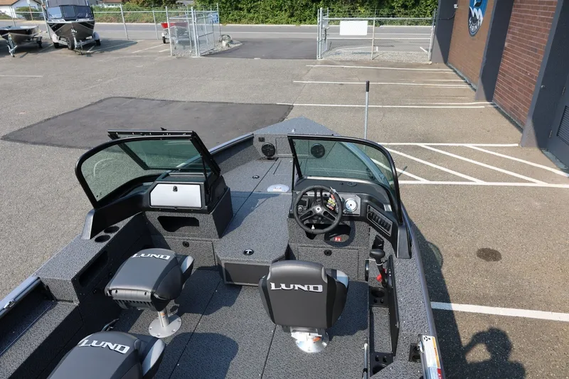 Slide: The Image of 2027 Lund 1875 Impact XS Sport boat interior with dual seats and steering console. - 46