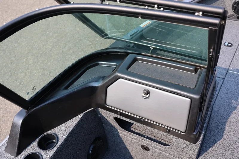 Slide: The Image of 2027 Lund 1875 Impact XS Sport boat dashboard with windshield and storage compartment. - 32