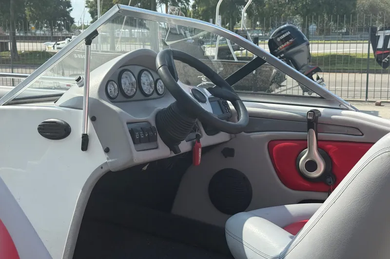 Slide: The Image of Interior of a 2006 Skeeter SL 190 boat, featuring steering wheel and dashboard controls. - 12