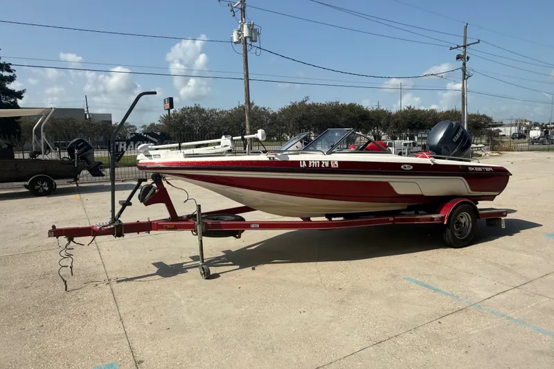 Slide: The Image of 2006 Skeeter SL 190 boat on trailer, parked outdoors under clear sky. - 7