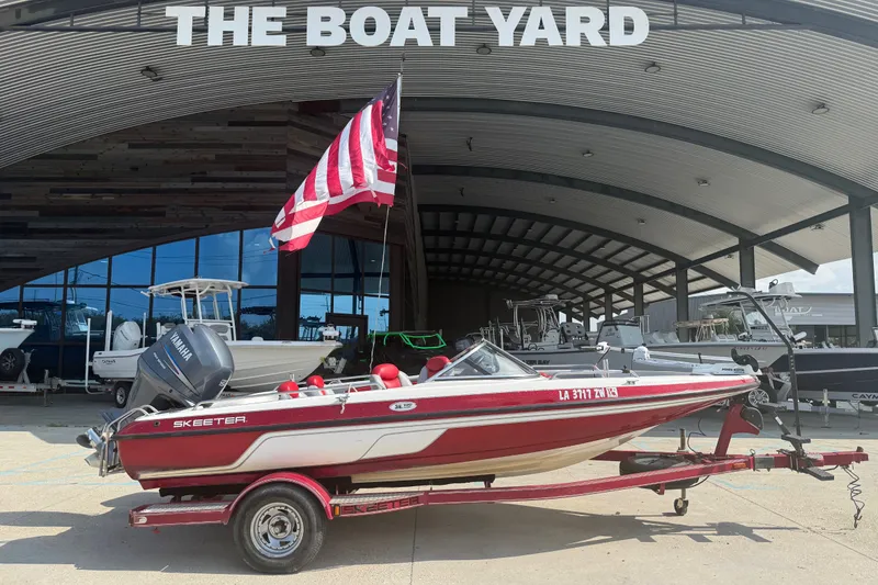Slide: The Image of 2006 Skeeter SL 190 boat with American flag at The Boat Yard dealership. - 1