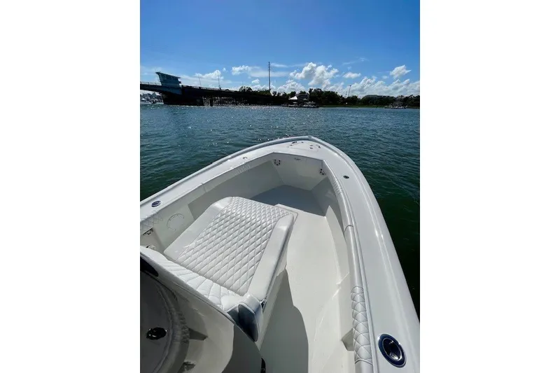 Slide: The Image of 2027 Pair Customs 27 Center Console boat on water, featuring sleek seating and clear skies. - 16