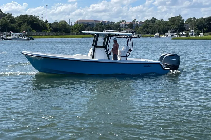 The Image of 2027 Pair Customs 27 Center Console boat cruising on a sunny day with Yamaha engine. - 1