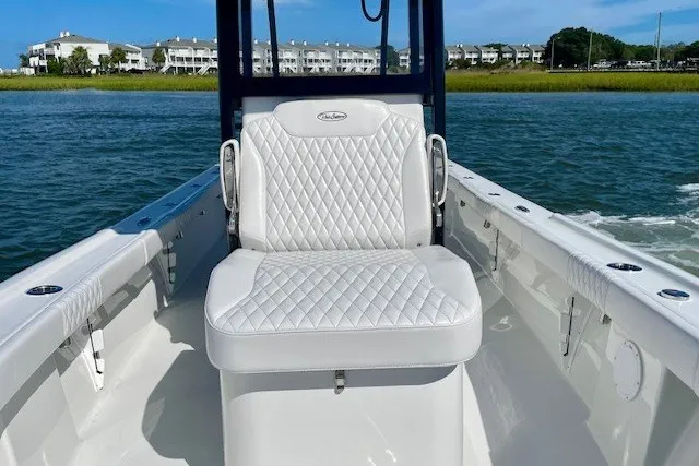 Slide: The Image of 2027 Pair Customs 27 Center Console boat with white quilted seating on open water. - 15