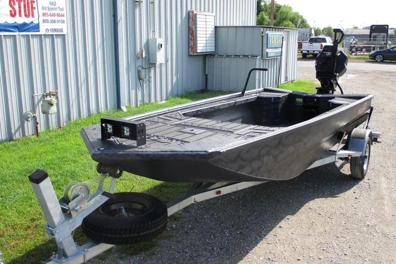 Slide: The Image of 2027 Gatortail 1854 Extreme boat on trailer near metal building. - 2