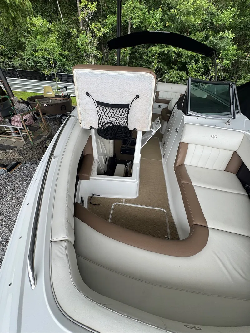 Slide: The Image of The image shows the cockpit of a 2015 Cobalt 296 boat with white and brown seating. - 18