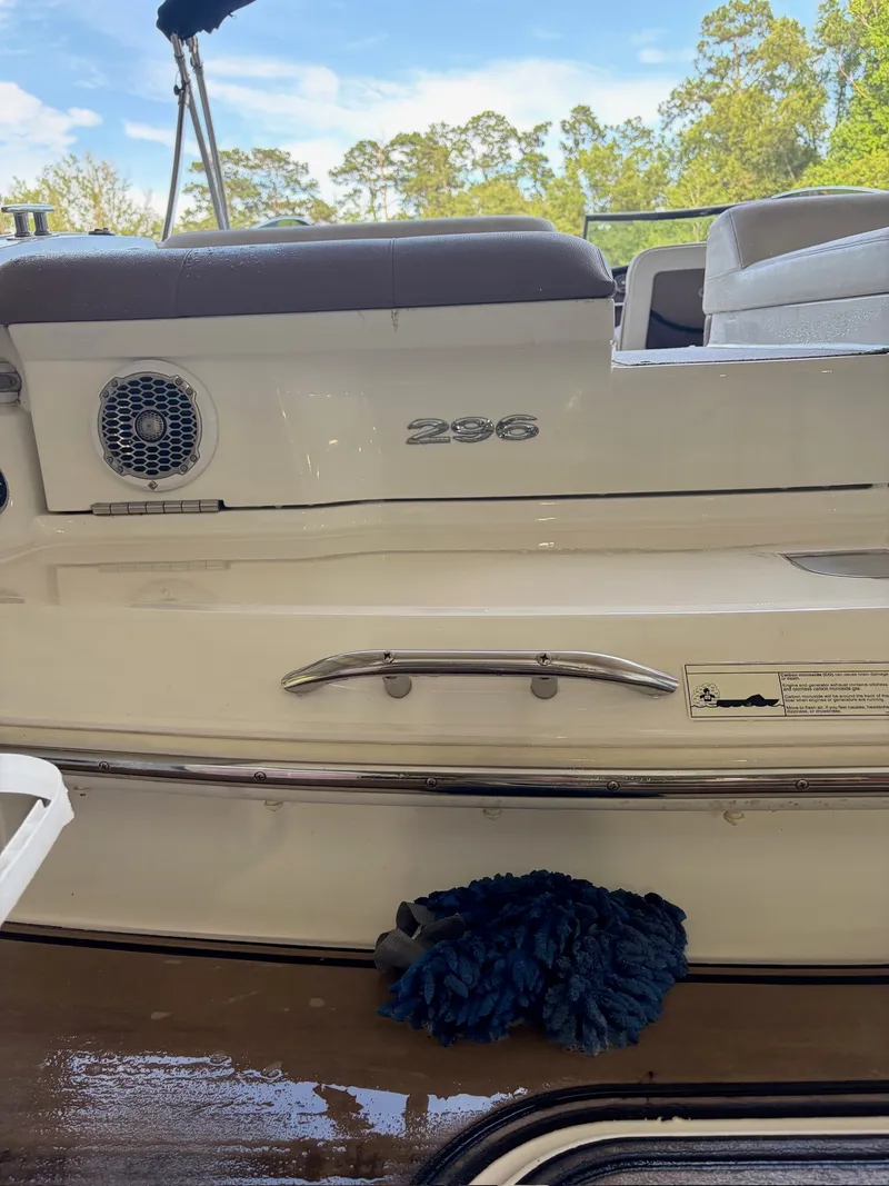 Slide: The Image of A 2015 Cobalt 296 boat with a white hull and stainless steel handles. - 29