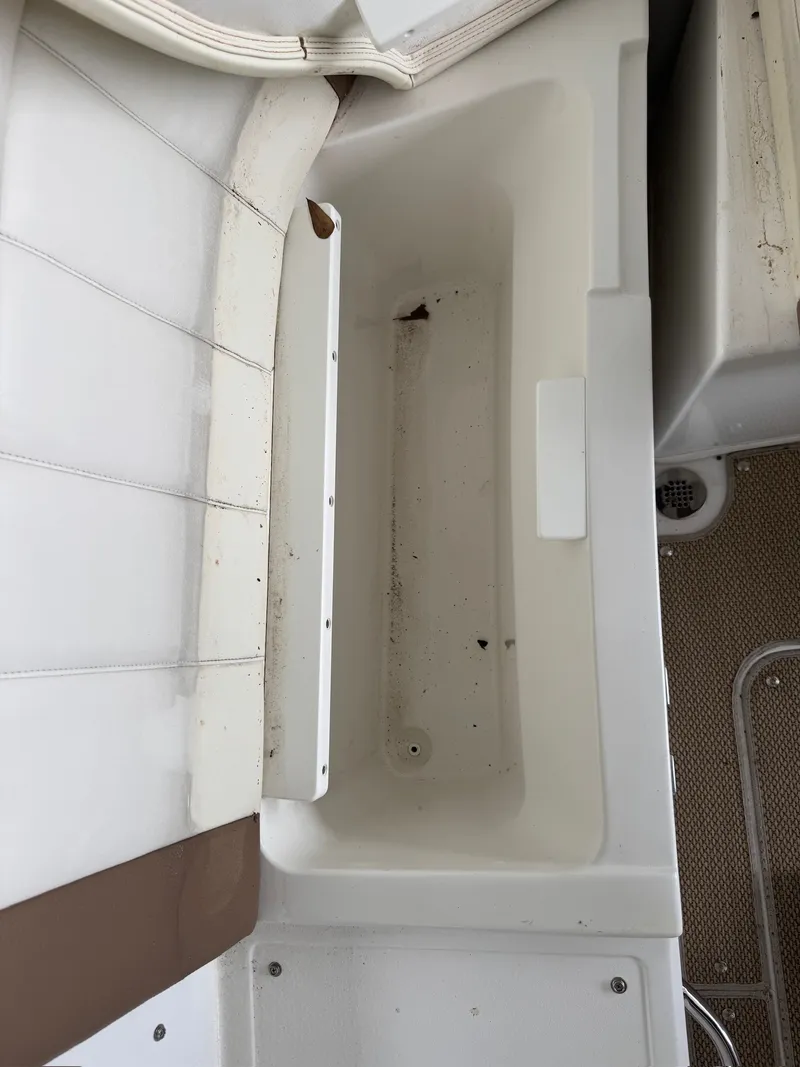Slide: The Image of An empty storage compartment on a 2015 Cobalt 296 boat. - 21
