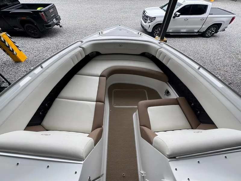 Slide: The Image of The image shows the spacious bow area of a Cobalt 296 boat with beige and white upholstery. - 15