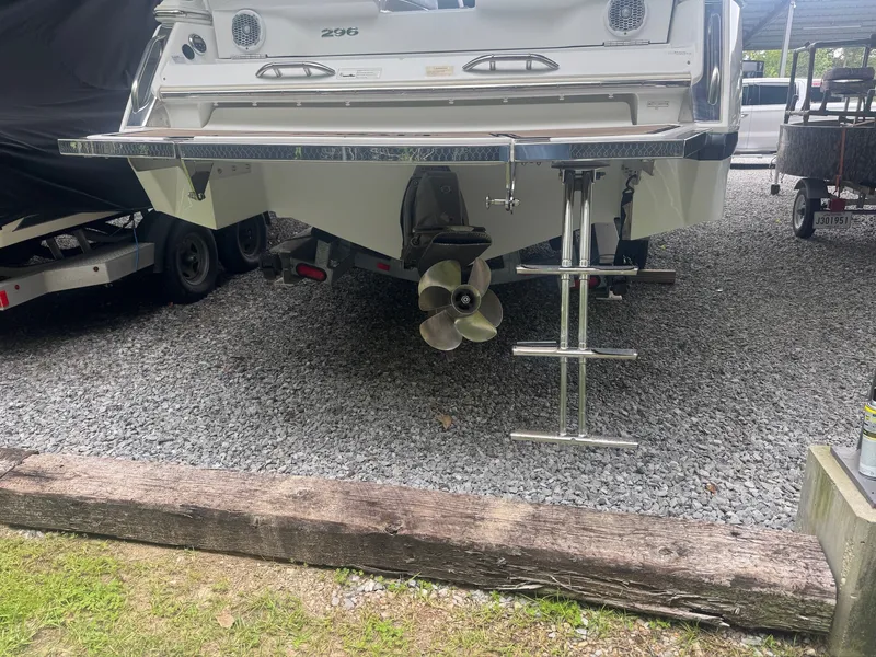 Slide: The Image of The image shows the stern of a 2015 Cobalt 296 boat with a swim ladder. - 4