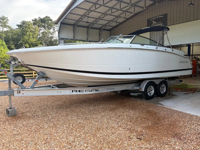 Slide: The Image of 2015 Cobalt 296 on a Regal trailer in an open shed. - 1