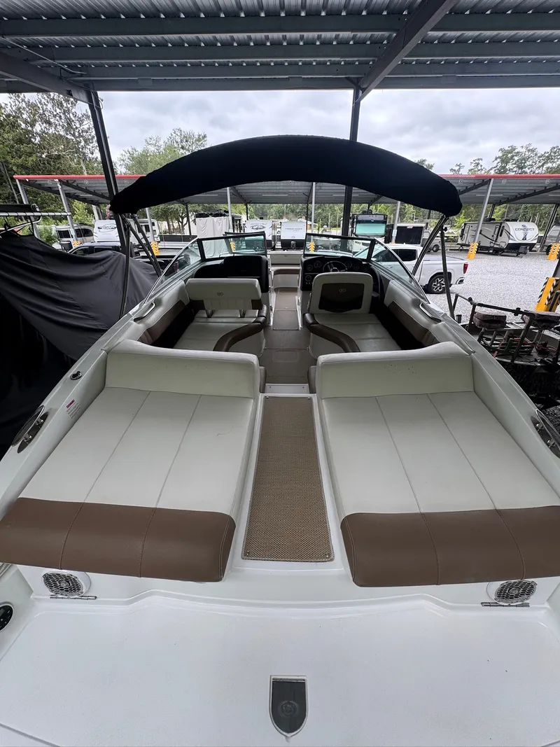 Slide: The Image of 2015 Cobalt 296 with spacious cockpit and comfortable seating under a black Bimini top. - 7