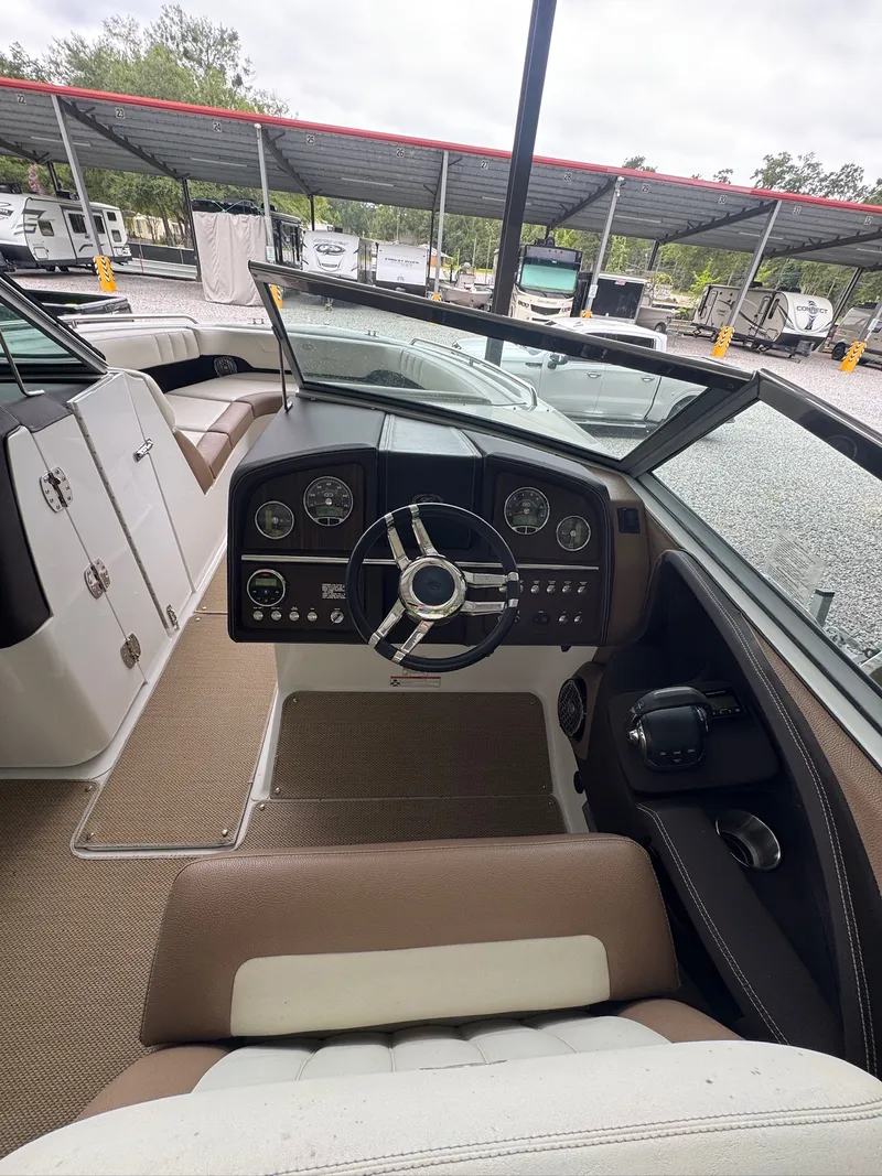 Slide: The Image of The image shows the cockpit of a 2015 Cobalt 296 boat with a sleek steering wheel and dashboard. - 11