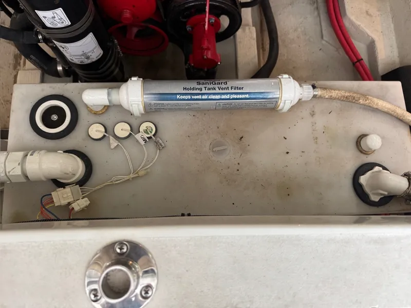 Slide: The Image of A SaniGard filter is mounted on a holding tank in a Cobalt 296 boat's engine compartment. - 26