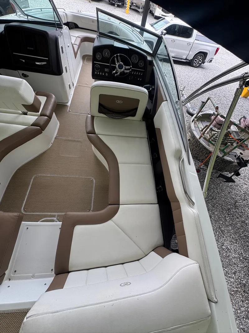 Slide: The Image of Interior of a 2015 Cobalt 296 with white and brown seating, steering wheel, and dashboard. - 9