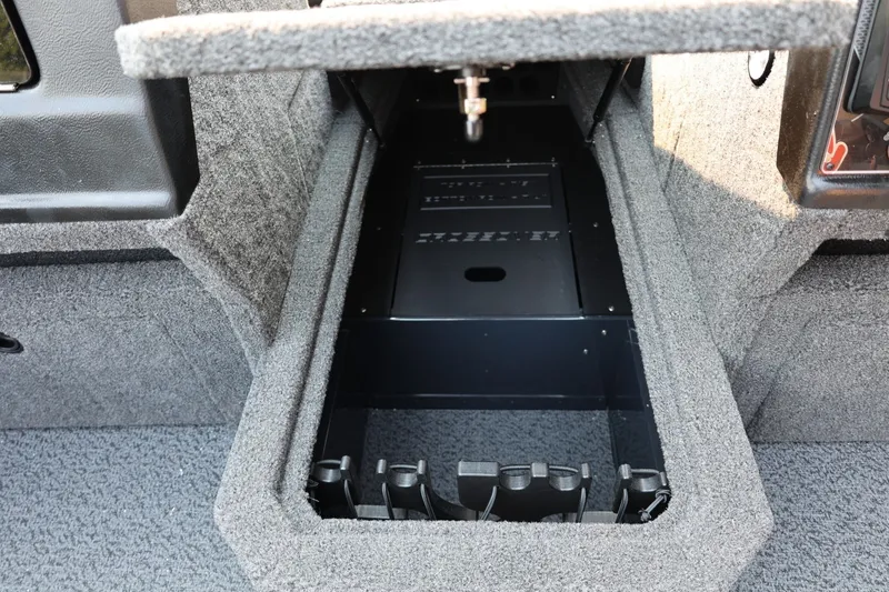 Slide: The Image of An open storage compartment in a boat with gray carpeted interior. - 22