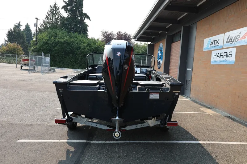 Slide: The Image of A 2027 Lund 1875 Crossover XS boat on a trailer in front of a building. - 5