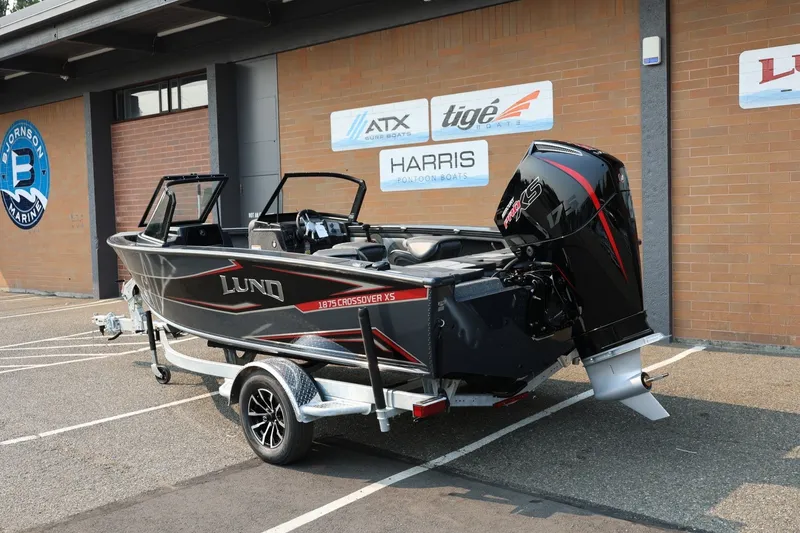 Slide: The Image of Lund 1875 Crossover XS 2027 on a trailer, featuring a powerful outboard motor. - 3