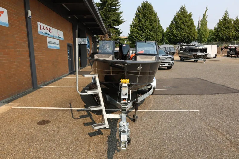 Slide: The Image of Lund 1875 Crossover XS 2027 parked in front of a building, with trailer and motor. - 11