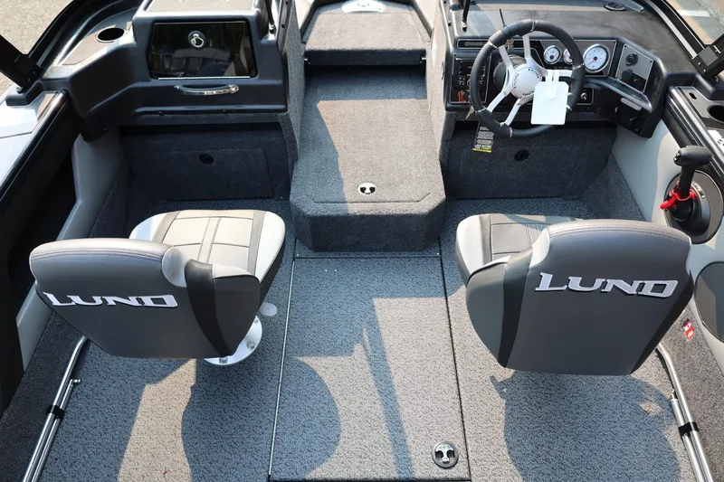 Slide: The Image of Interior view of a Lund 1875 Crossover XS boat with two cushioned seats and gray carpeting. - 37